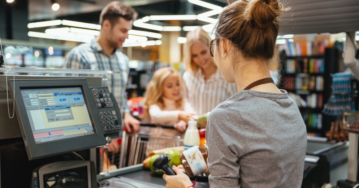 family standing at the cash counter