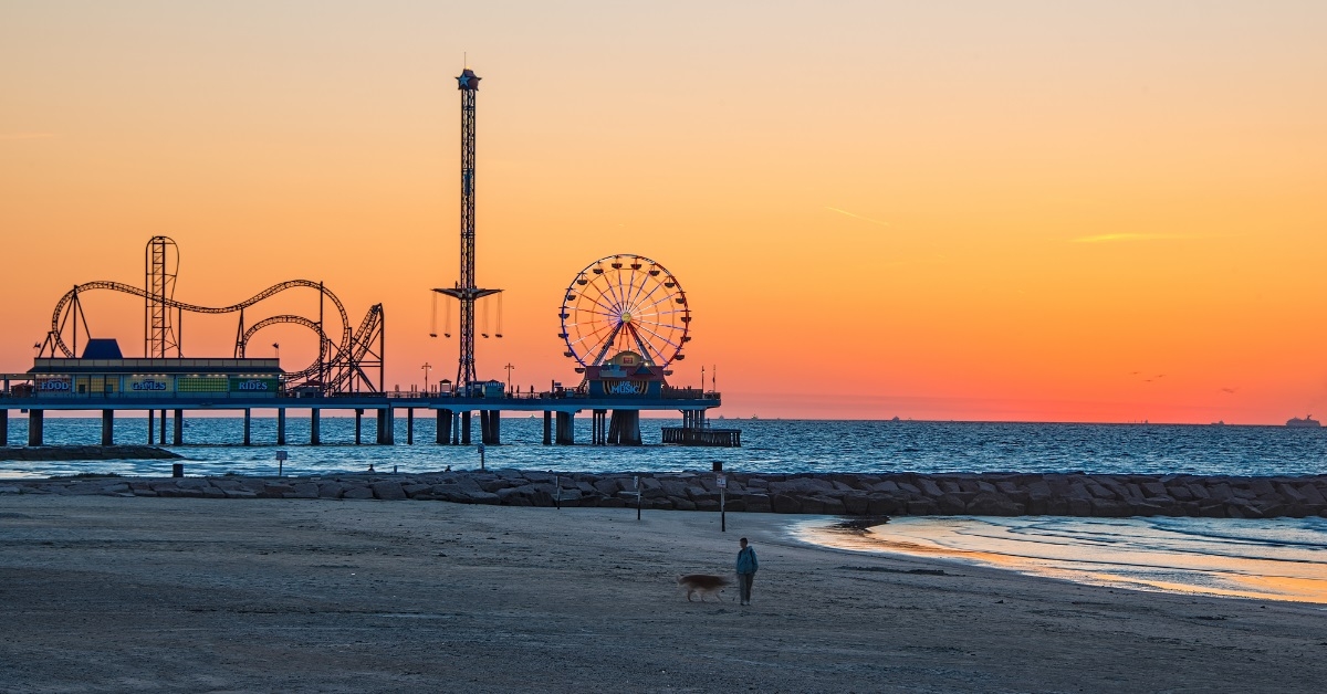 galveston sunrise on beach with rides