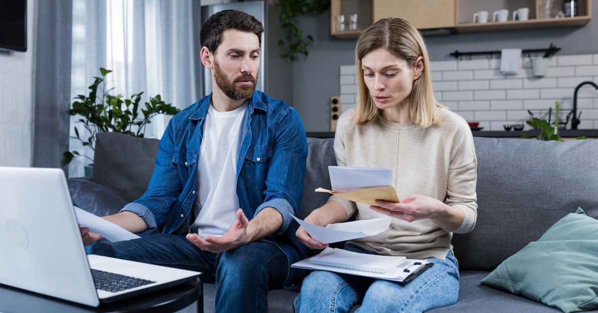 young couple going through bills