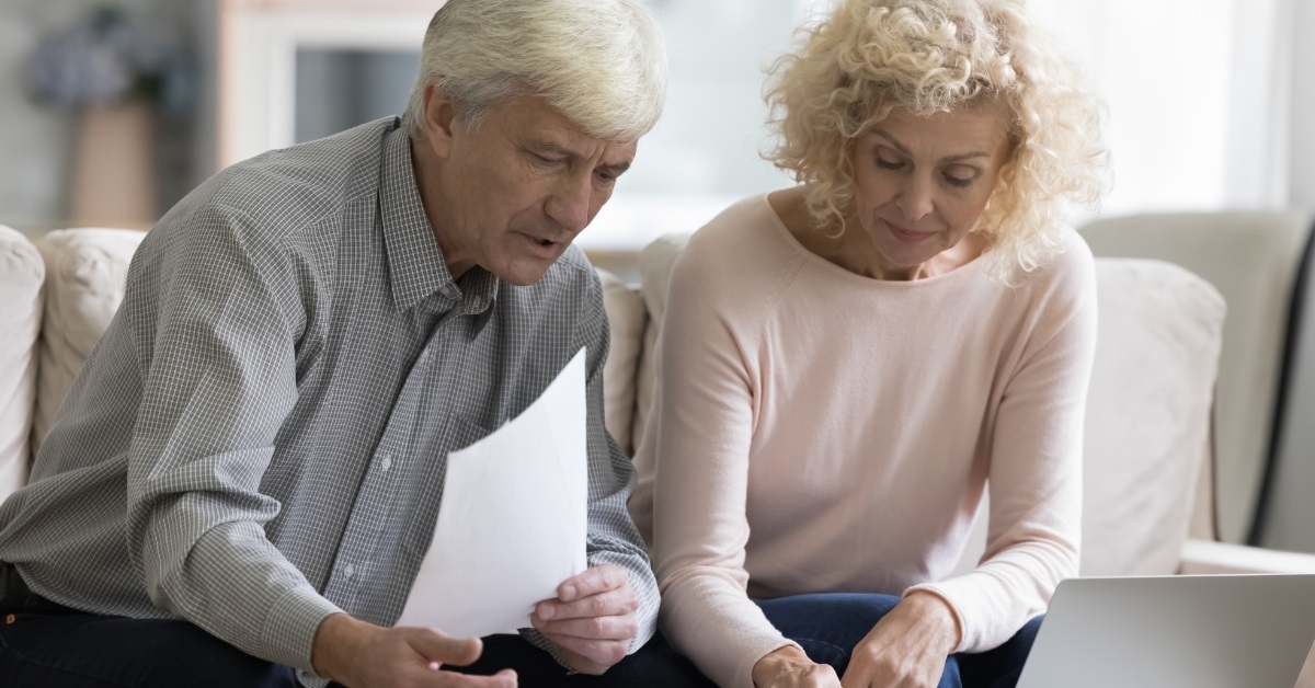 senior couple double checking receipts