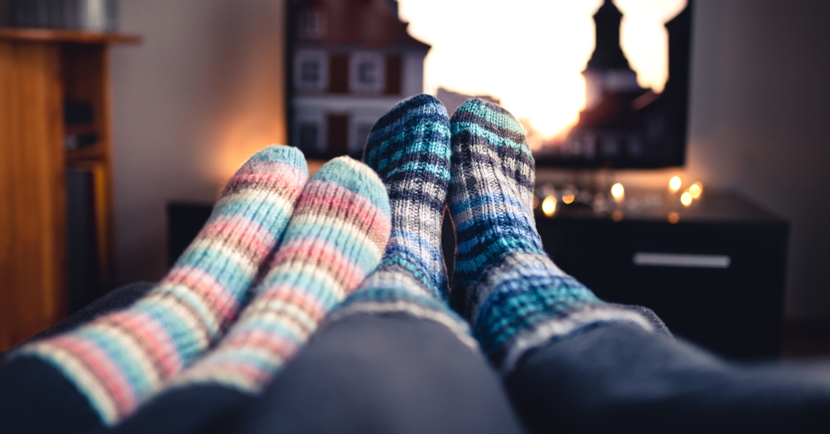 couple with socks watching TV