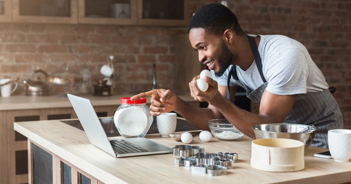 african american man baking using laptop