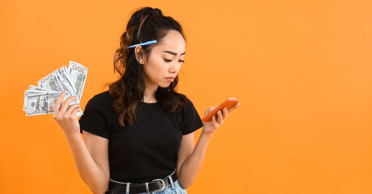 worried woman holding money and calculator