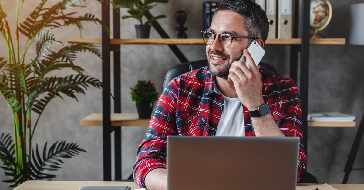 man talking on phone at work