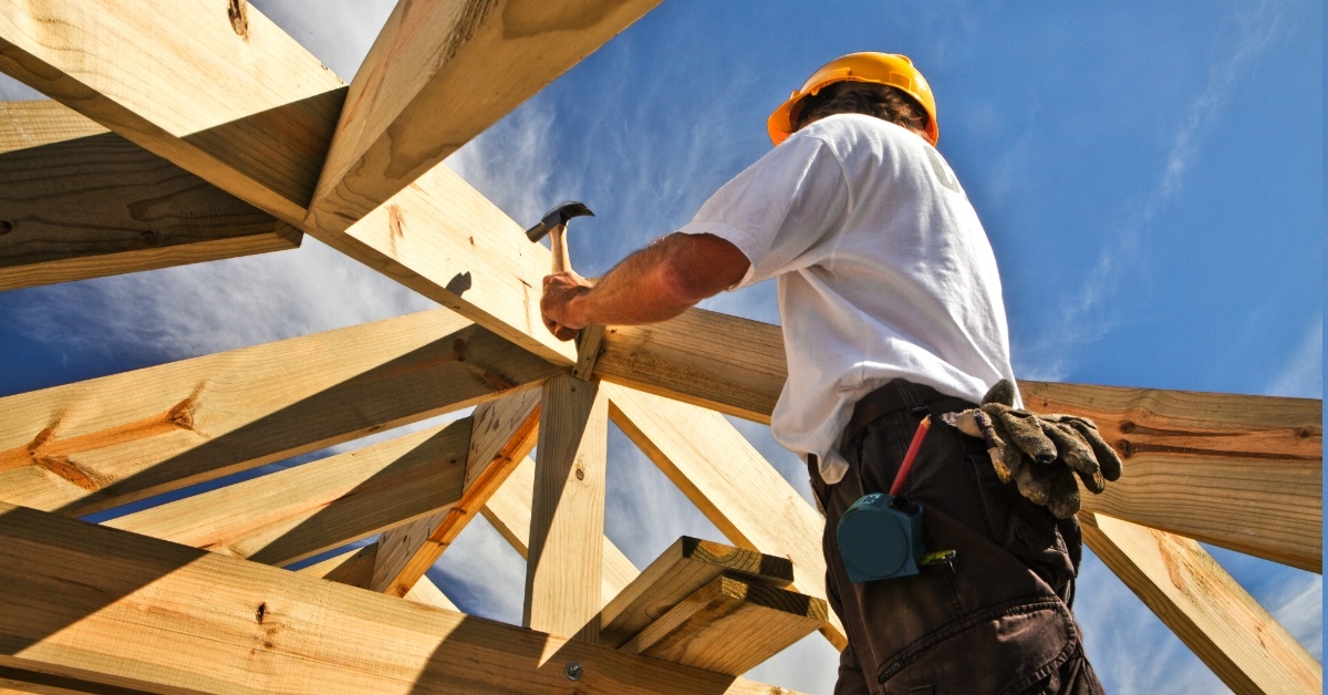 male carpenter fixing roof