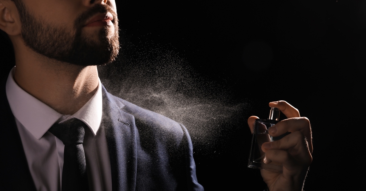man spraying luxury perfume