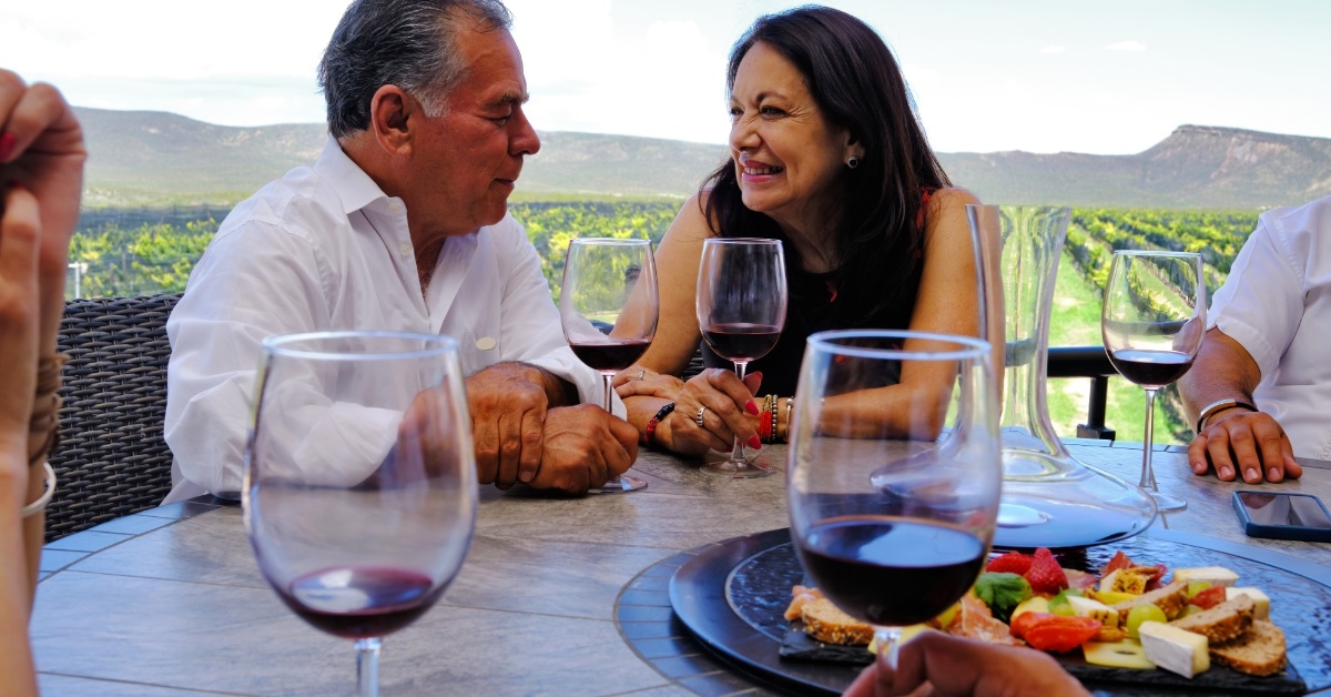 senior couple having wine at winery