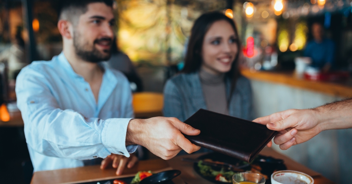 man paying bill with cash