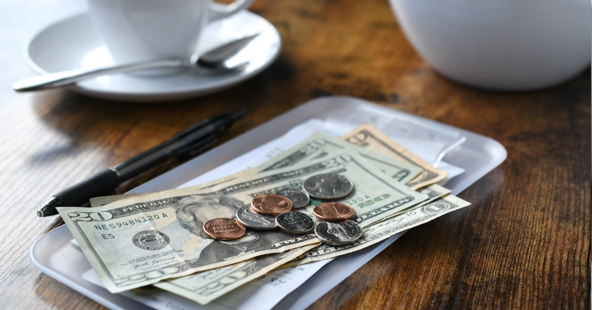 money on coffee table at cafe
