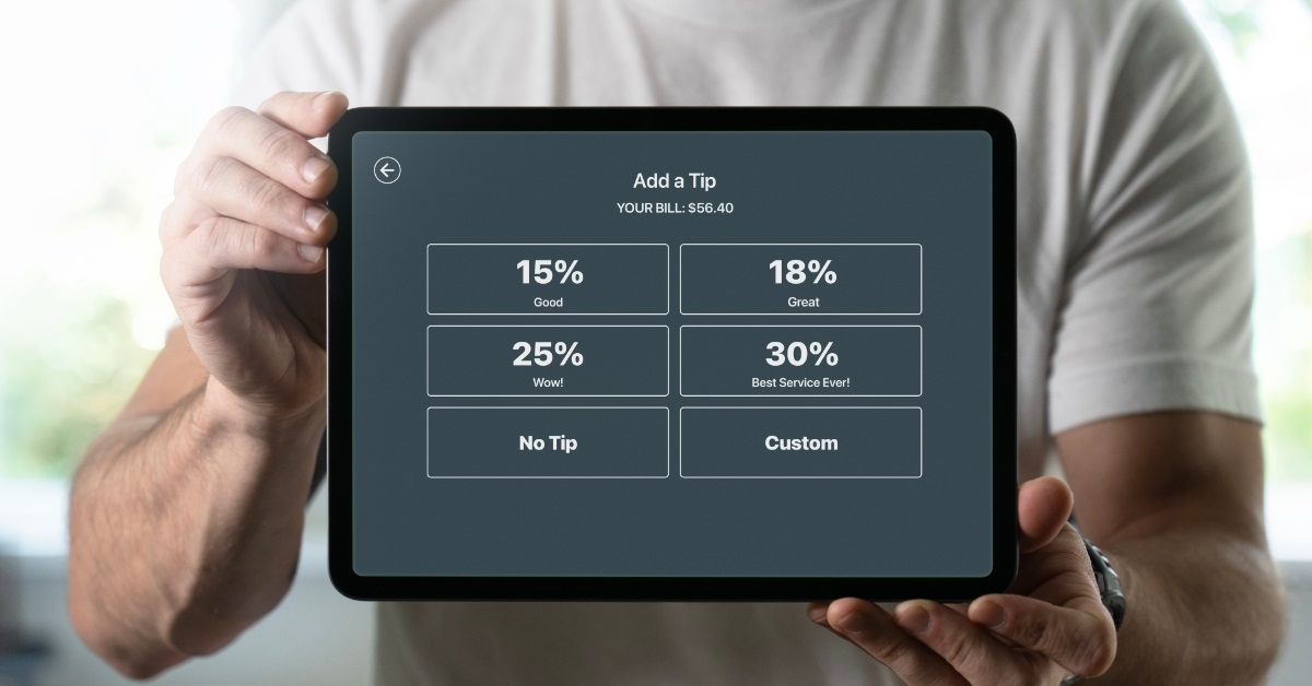 man asking for tip using tablet