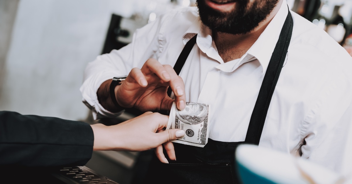 barman receiving payment from woman