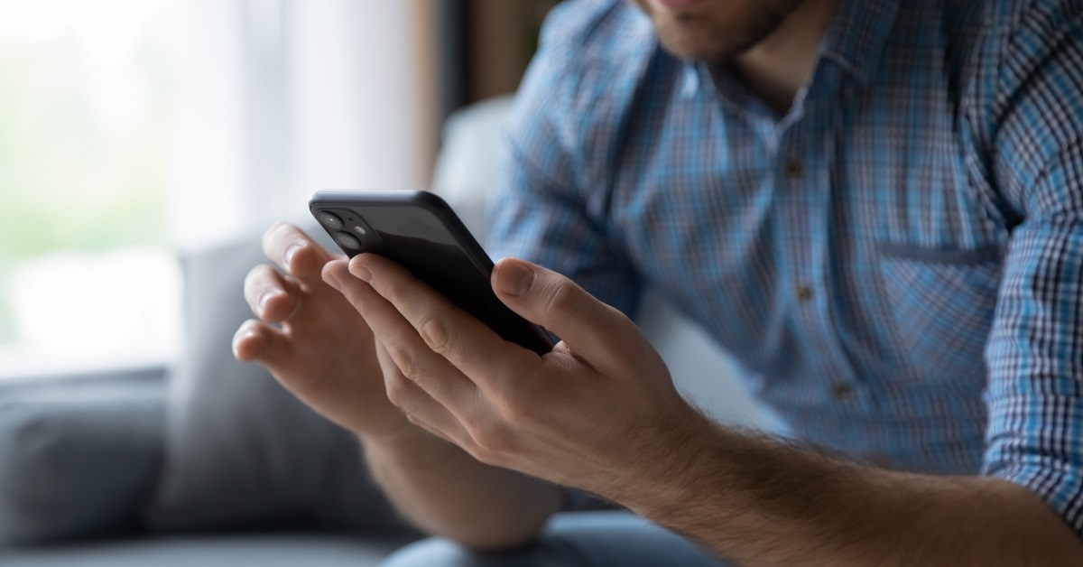man using smartphone at home