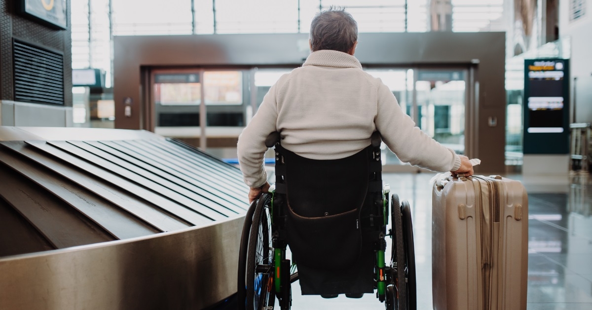 senior man in wheelchair at airport