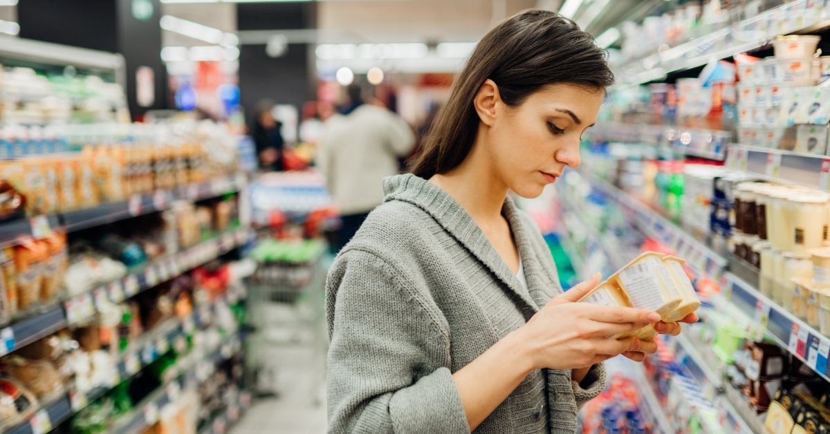woman reading ingredients at supermarket