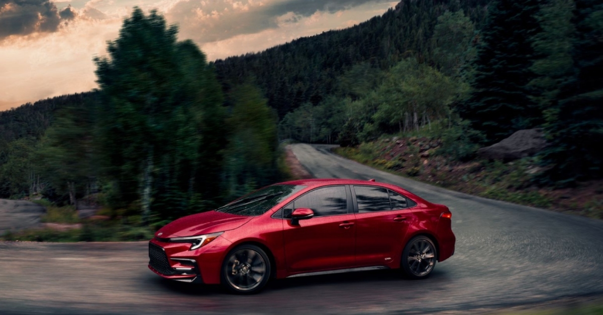 red toyota corolla driving in turns