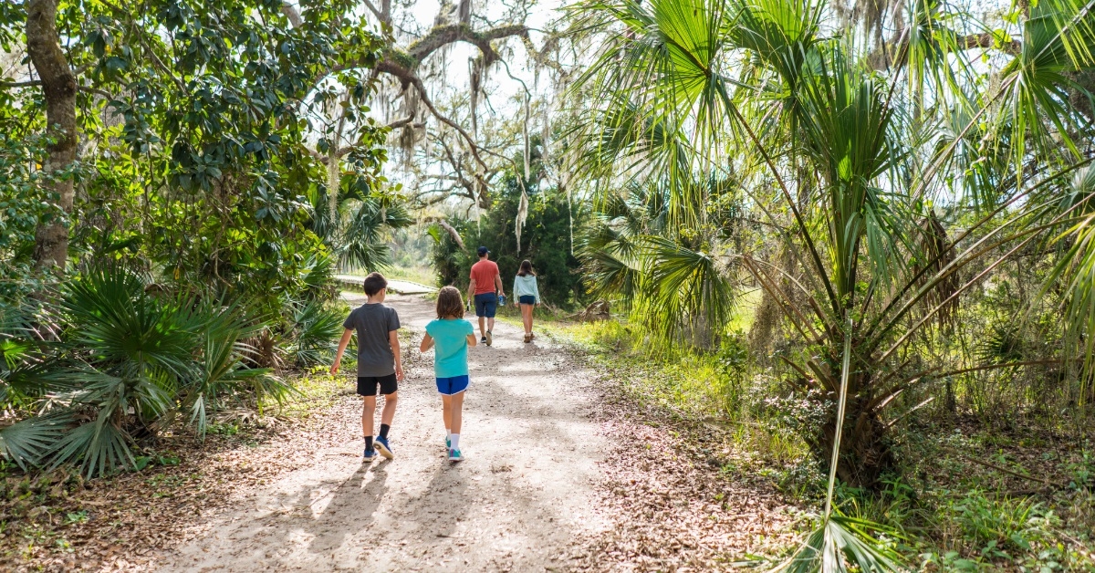 family hiking on trail in florida