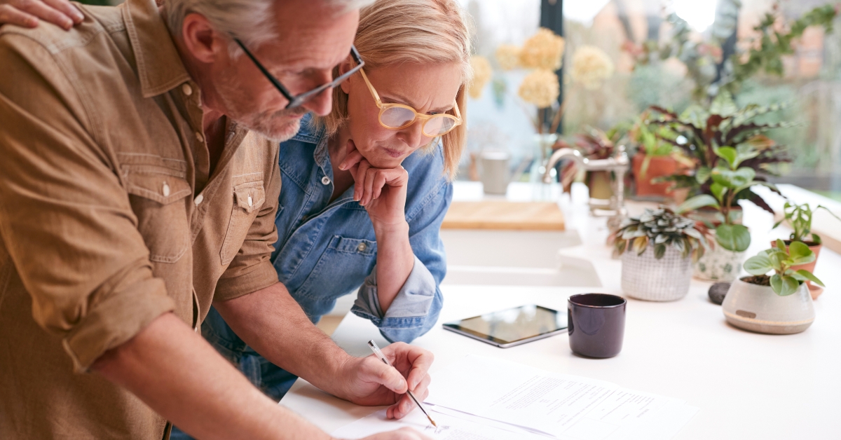 mature couple signing paperwork