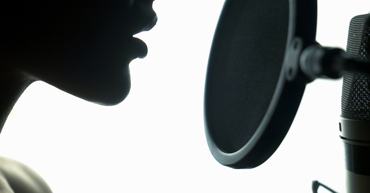 young woman recording a song