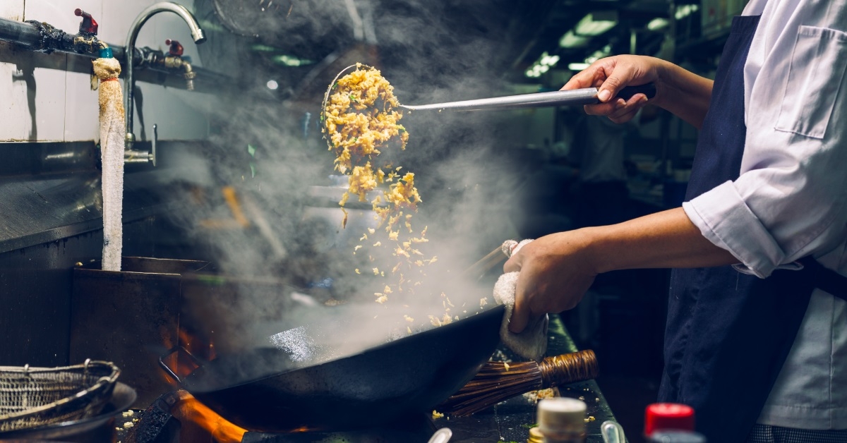 chef preparing fried rice in restaurant