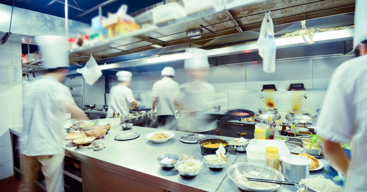 chefs working in busy restaurant kitchen