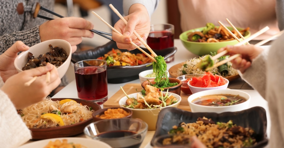 friends enjoying chinese food at restaurant