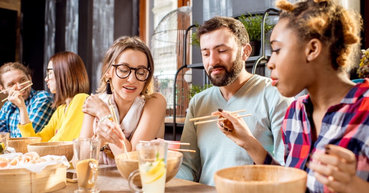 friends having asian food at restaurant