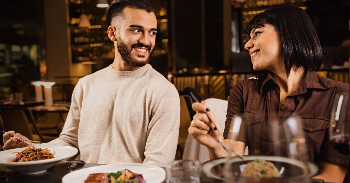 romantic couple eating at restaurant