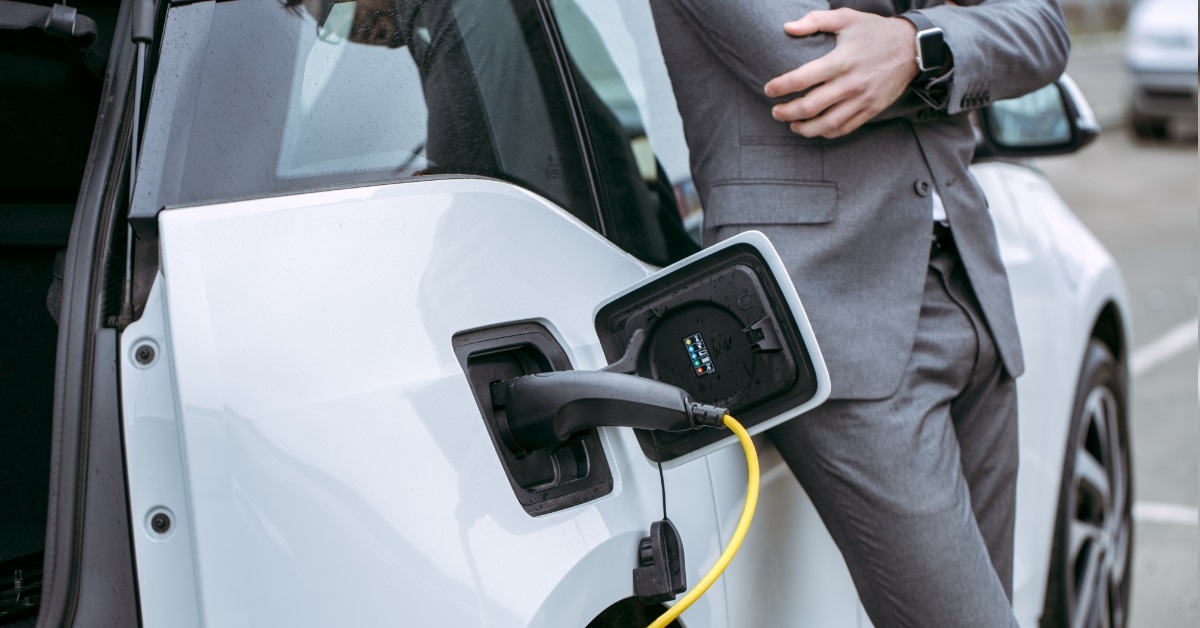 businessman charging car at charging station