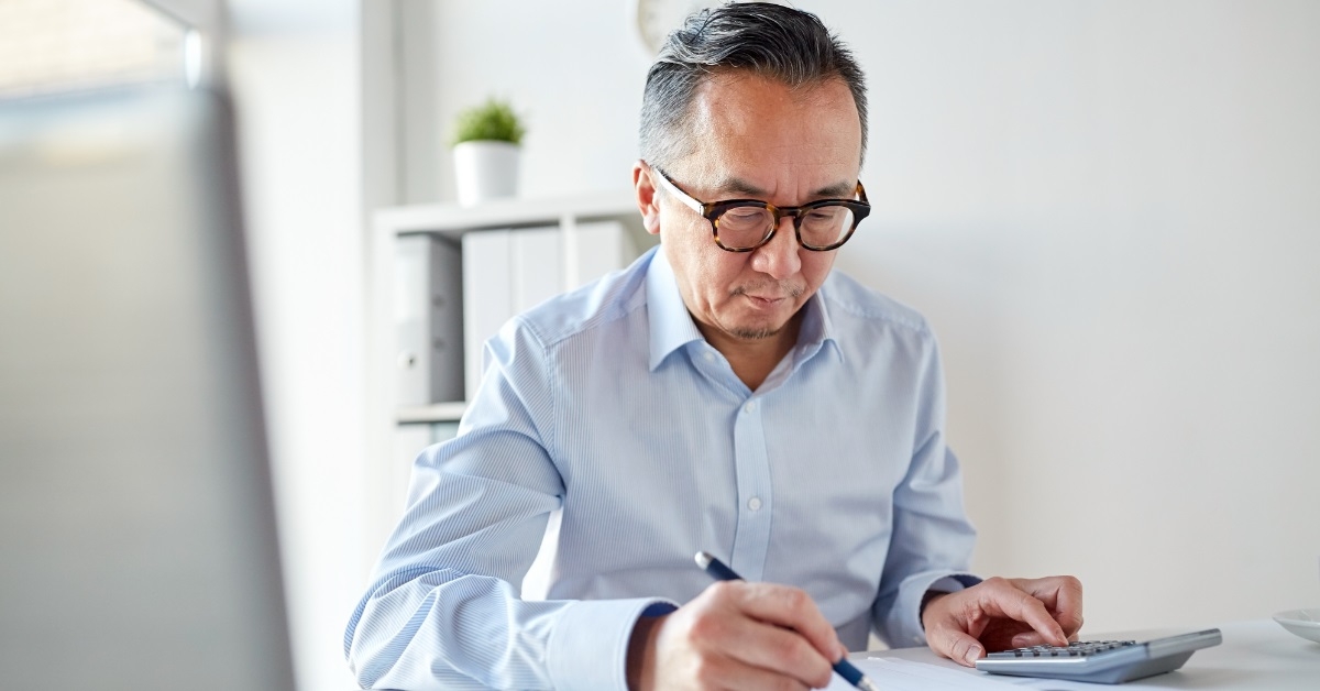 asian businessman reviewing bills at work