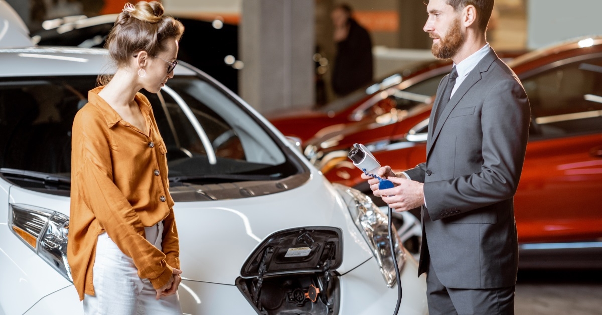 manager selling electric car to client