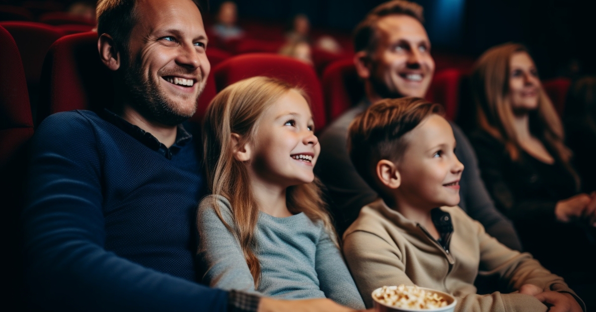 family sitting in a movie theater