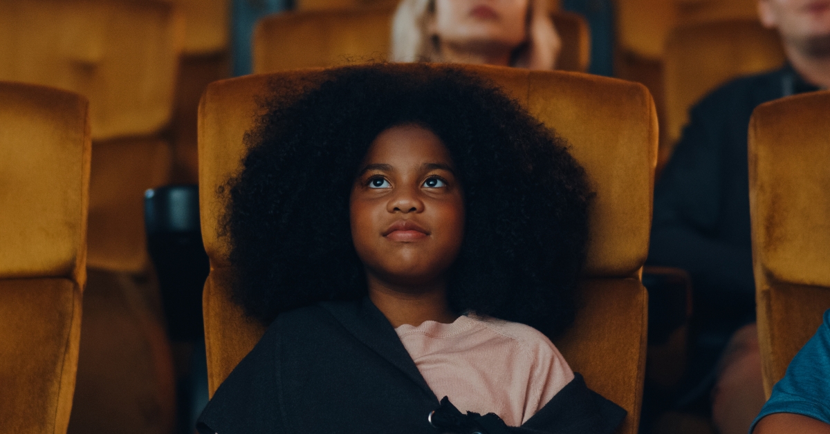 girl laughing while watching film