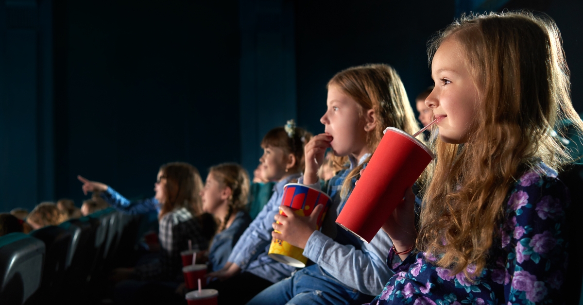 girl sipping her drink in cinema