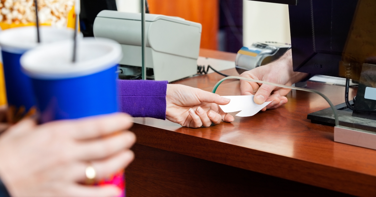 woman buying movie tickets