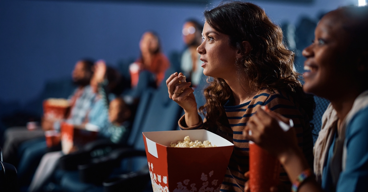 young woman eats popcorn