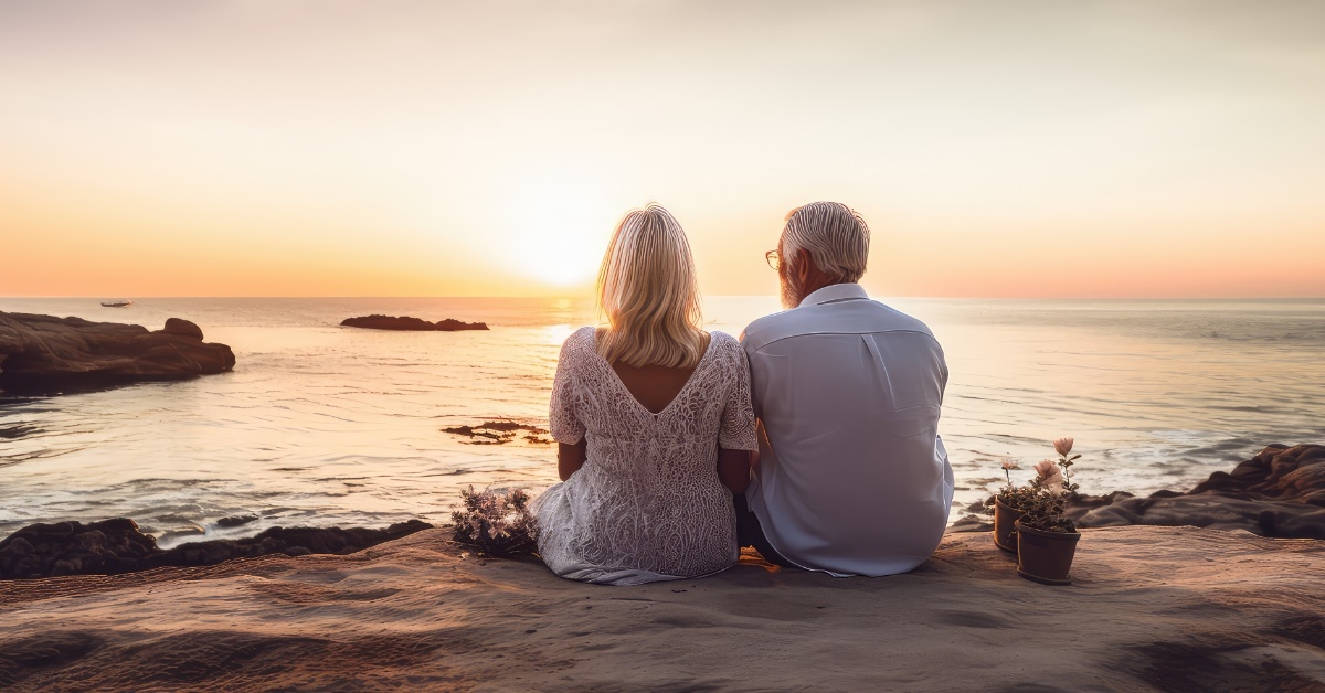 senior couple enjoying sunset at beach