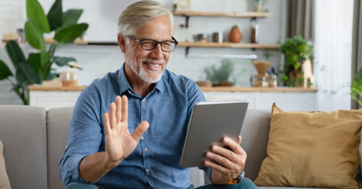 senior man video calling on tablet