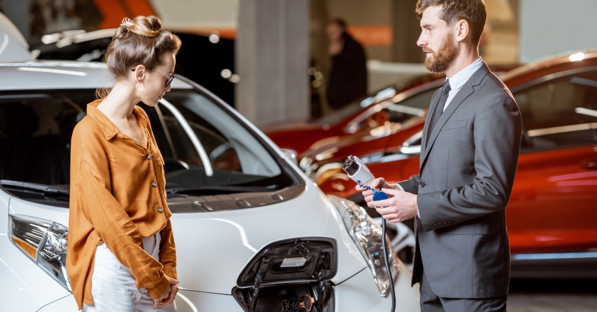 sales manager showing electric car