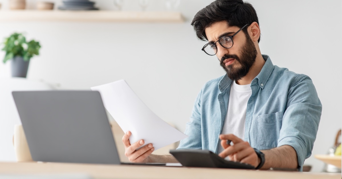 man frustrated at bills at work