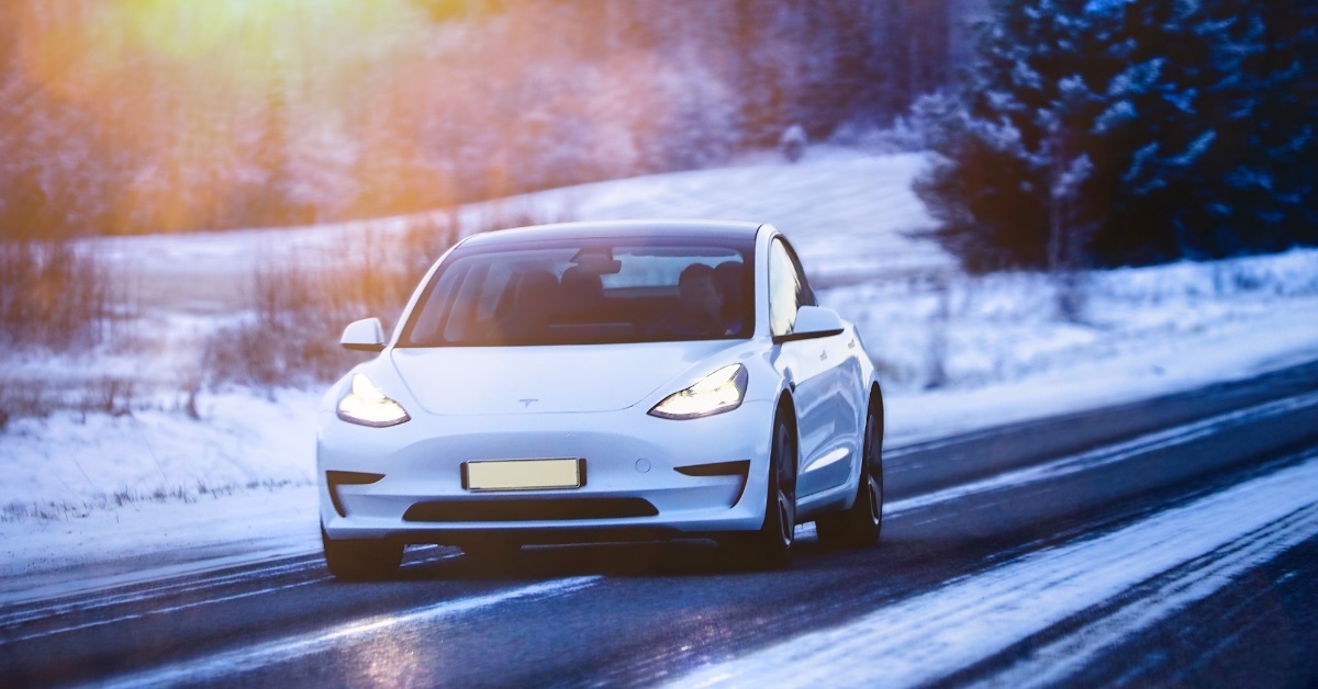 white tesla on road during winters