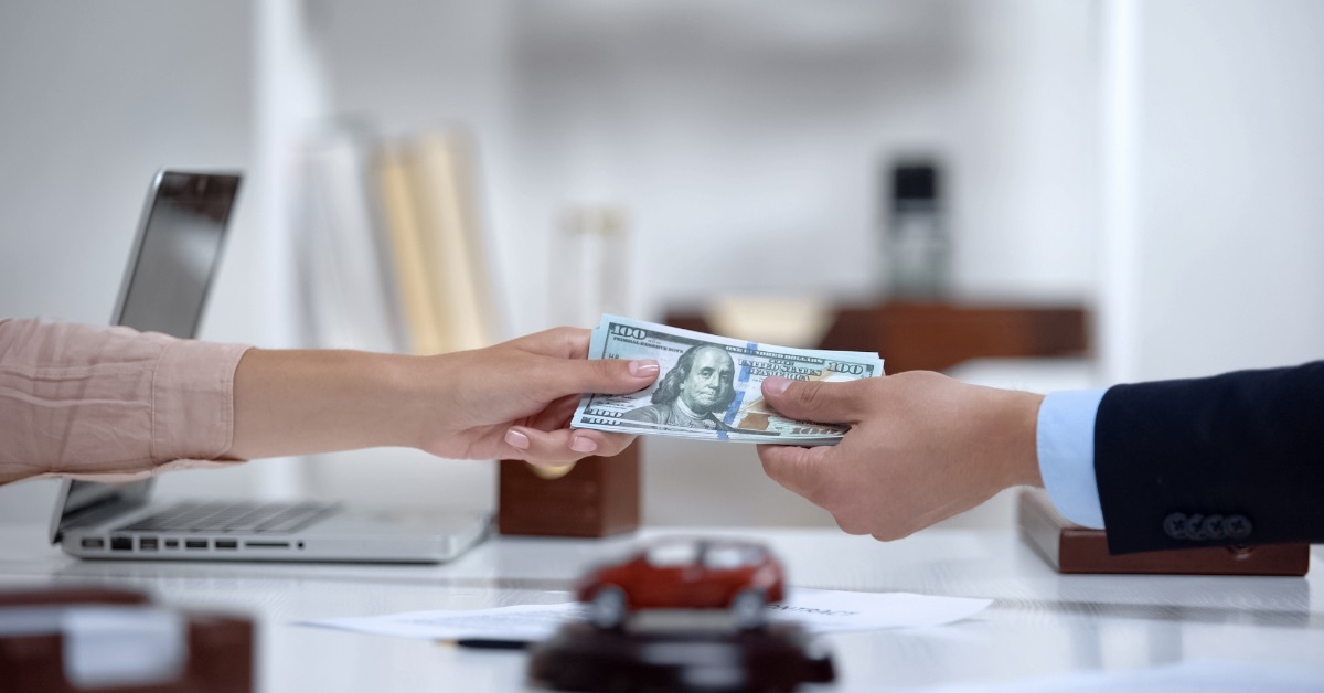 woman giving payment to sales manager