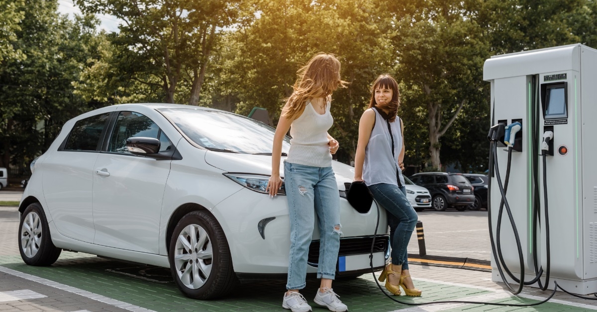 woman friends at car charging station