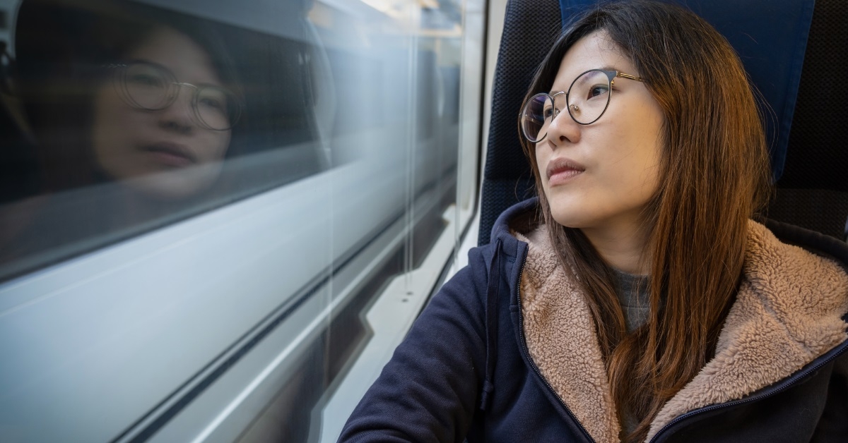 depressed asian woman traveling in train