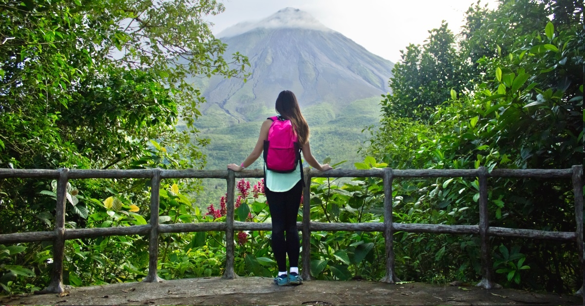 woman admiring arenal volcano costa rica