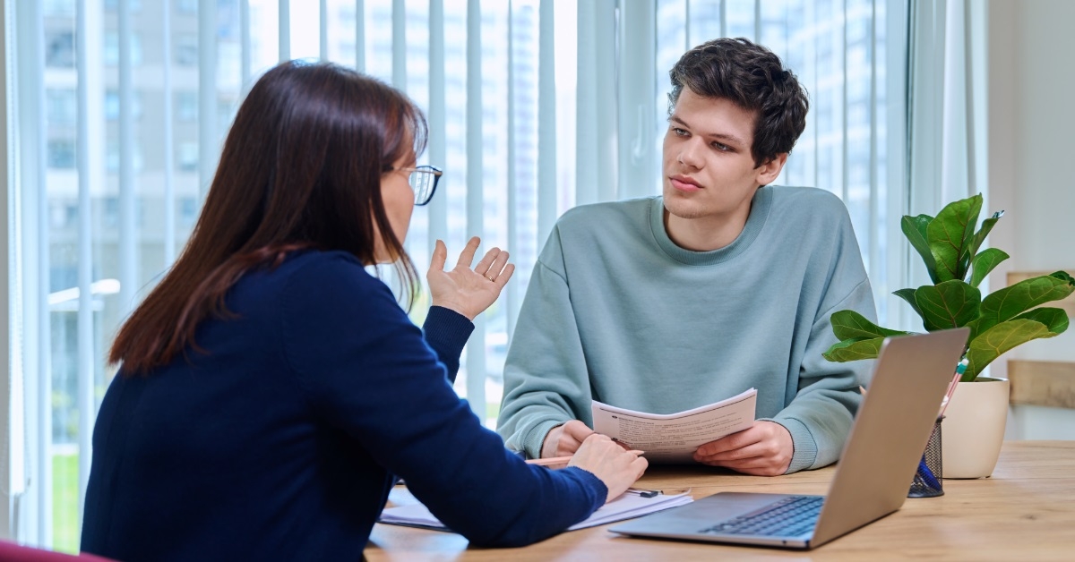 female teacher teaching male student