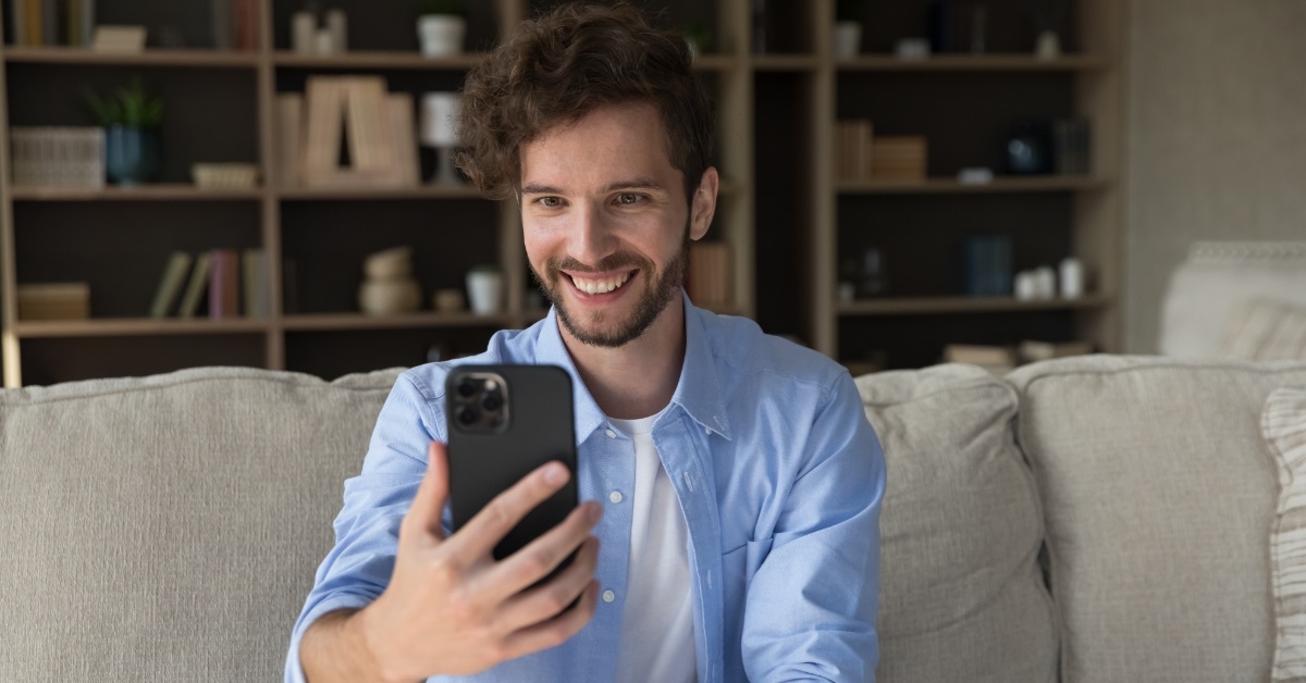 happy man video calling using smartphone