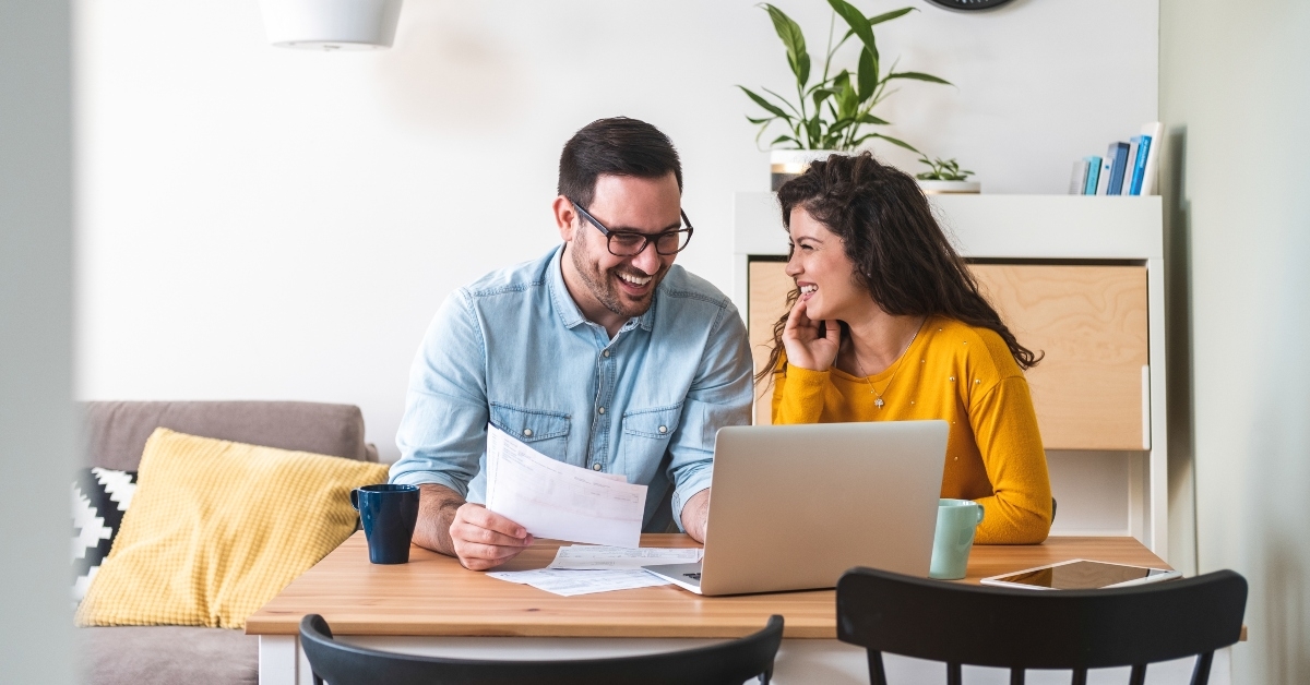 smiling couple managing finances