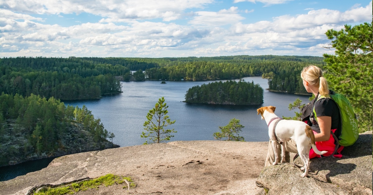 woman hiking national park with dog