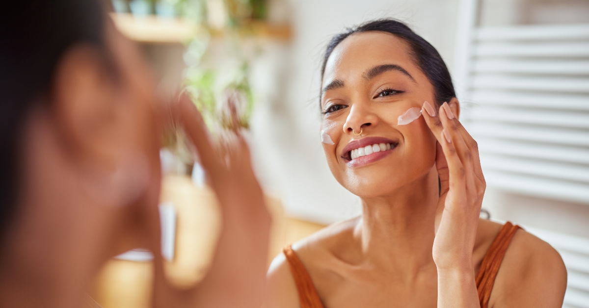 woman applying moisturizer