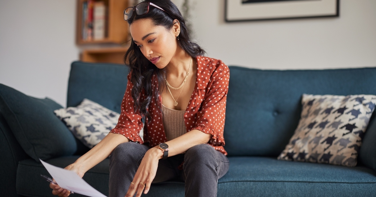 woman reading bills at home